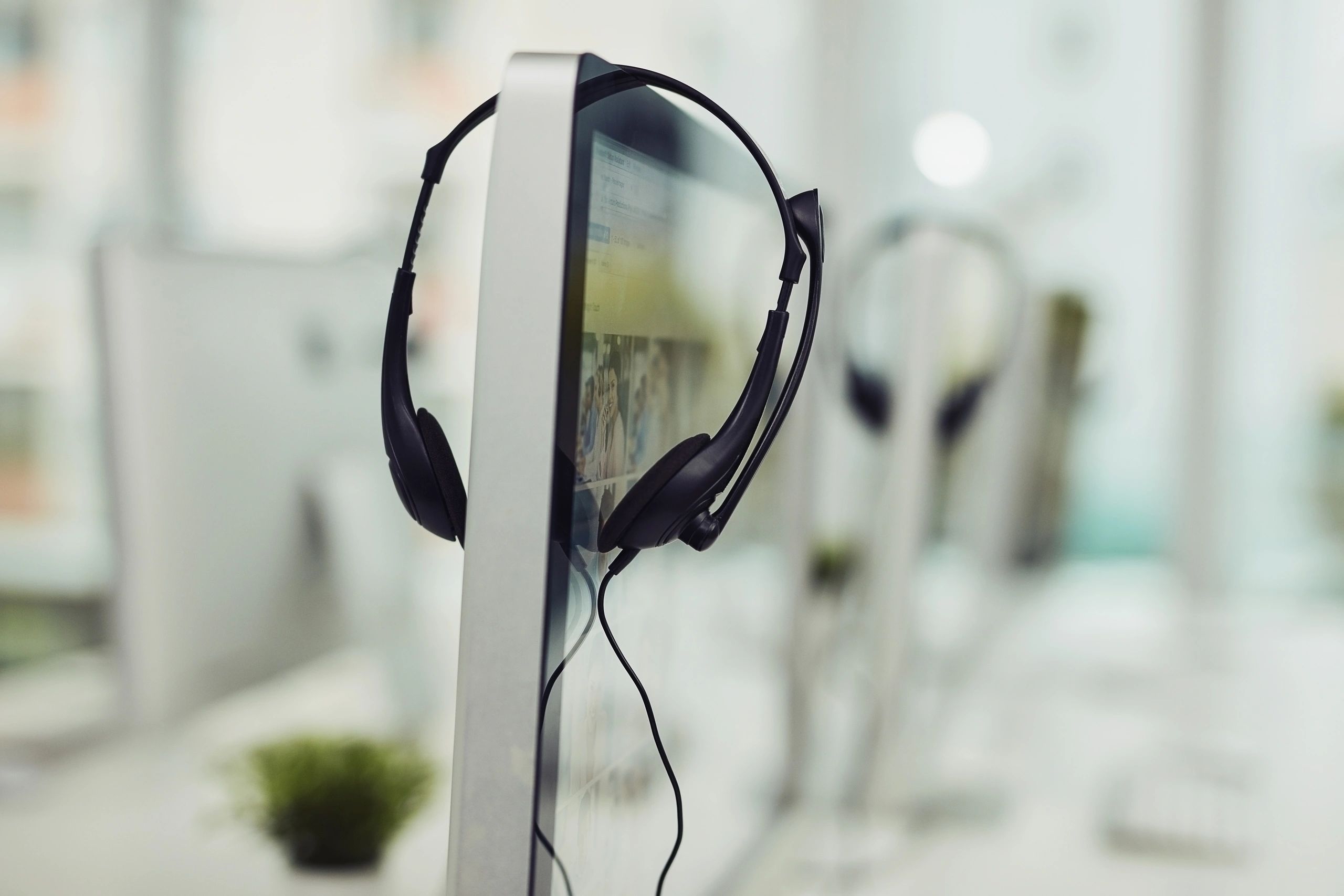 Office headset hanging on a monitor