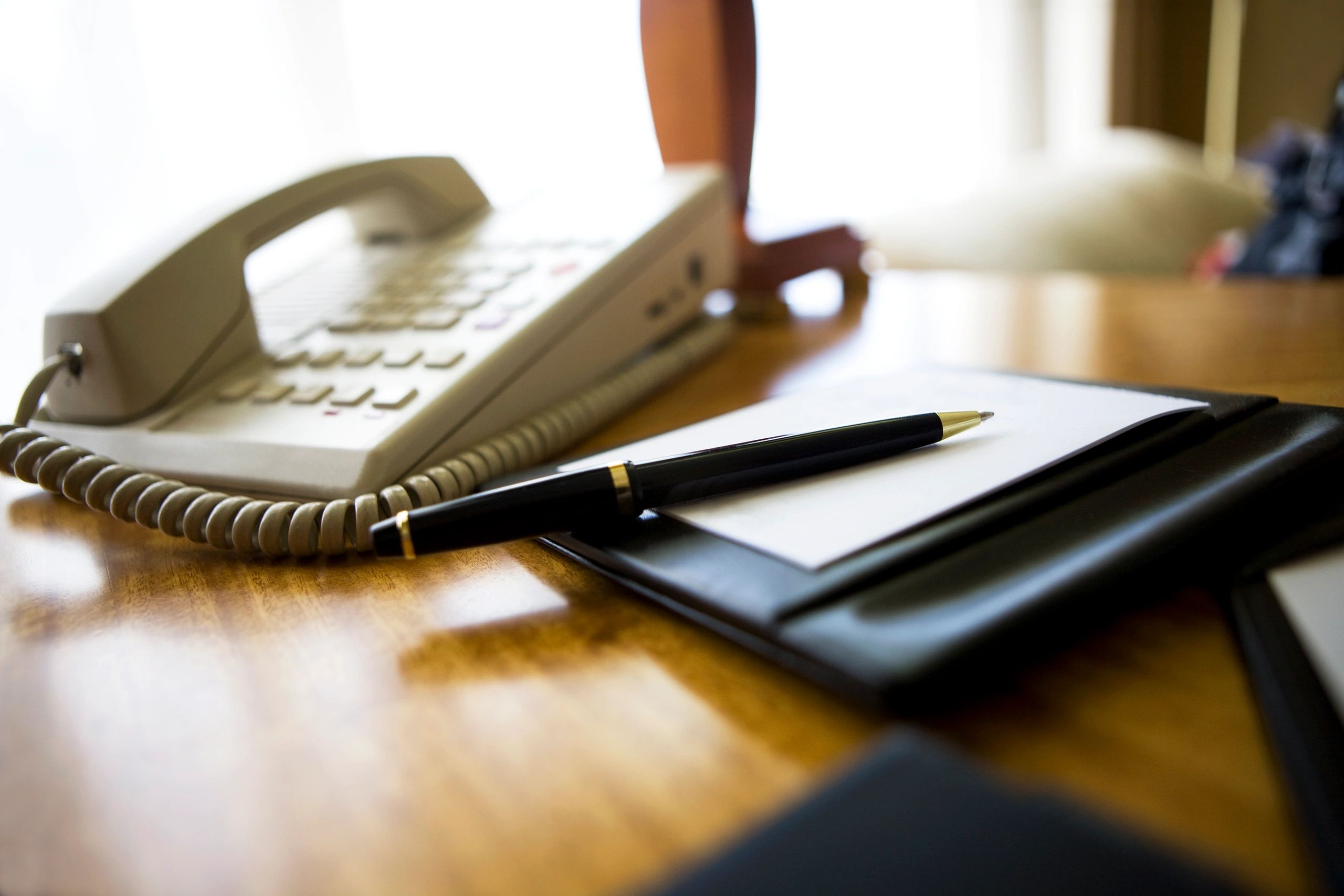 Notepad and pen on a meeting table