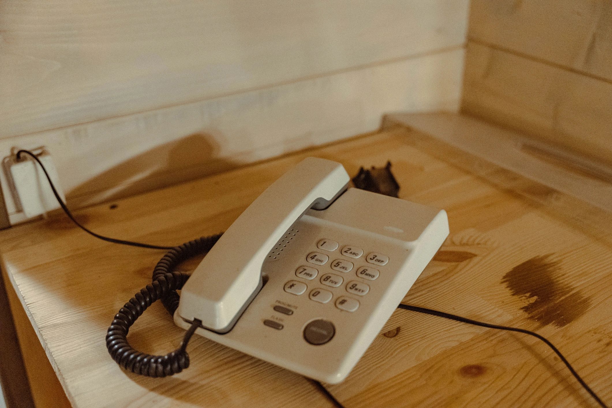 Desk phone on a wooden desk